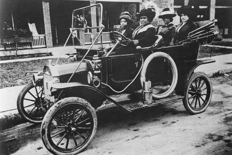 A photograph of Sarah Breedlove driving a car she was better known as Madam C.J. Walker the first woman to become a self made millionaire in the United States