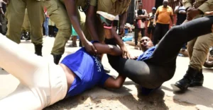 A protester being arrested by police in Kampala on Monday