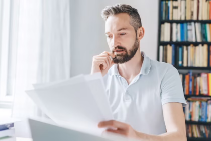 man filling out paper job application