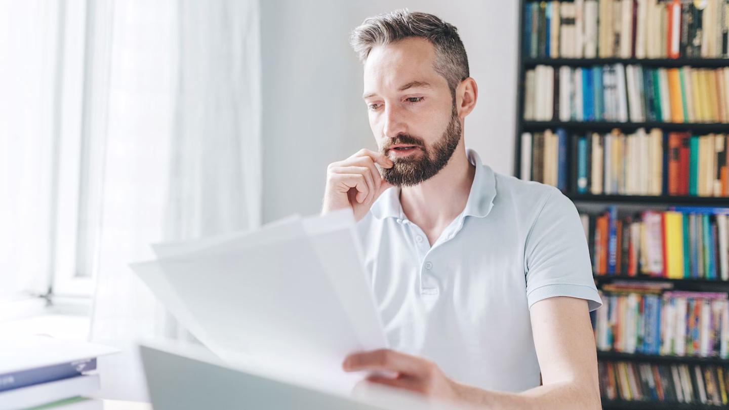 man filling out paper job application