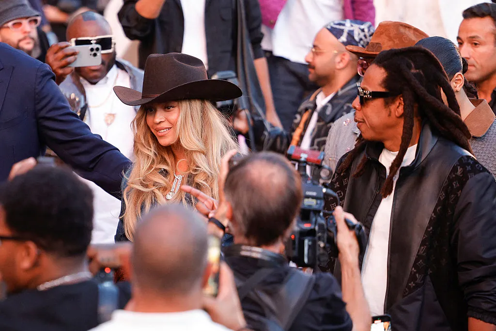 US rapper Jay-Z (R) and US singer-songwriter Beyonce (C)