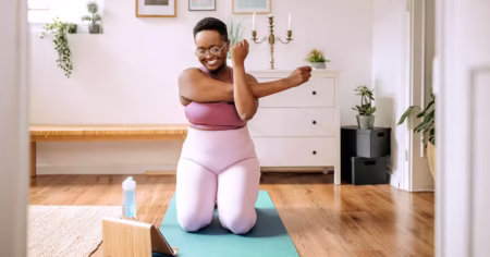 Tips for Overcoming Barriers to Developing Healthy Habits woman doing yoga at home during work break