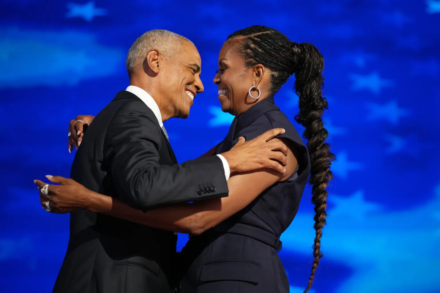Former U S President Barack Obama (L) greets former first lady Michelle Obama