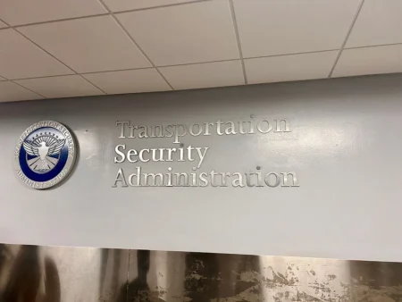 TSA May Finally Let You Keep Your Sneakers On at Security TSA, Transportation Security Administration sign in St Thomas Airport, USVI