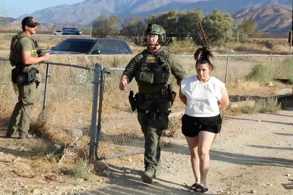 A handcuffed Rebecca Haro is escorted from her Cabazon home during her arrest