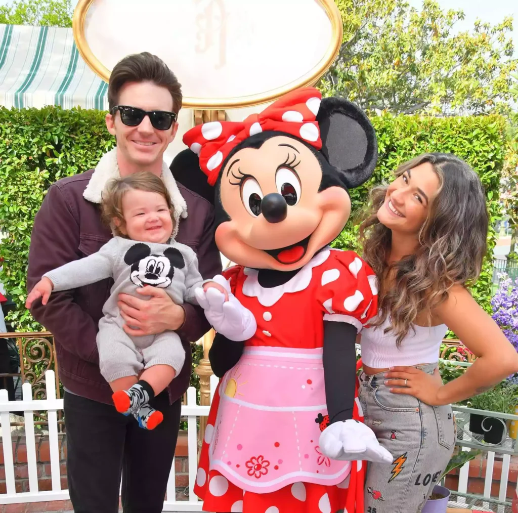 Drake Bell, Janet Von Schmeling and their son pose with Minnie Mouse