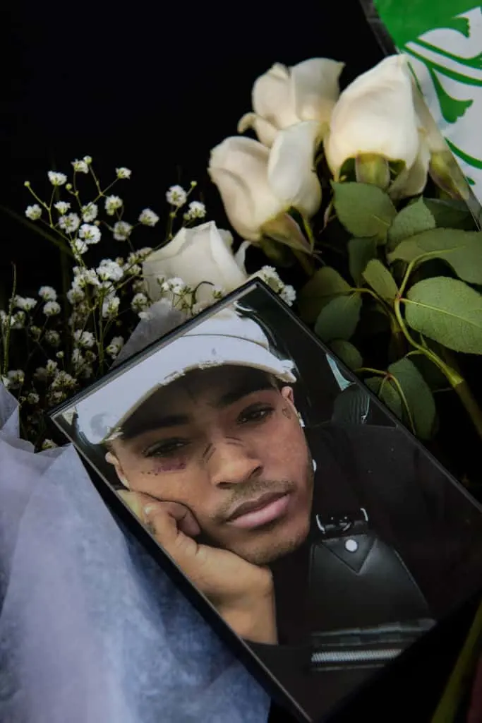 Fans leave items at a makeshift memorial outside the XXXTentacion Funeral & Fan Memorial