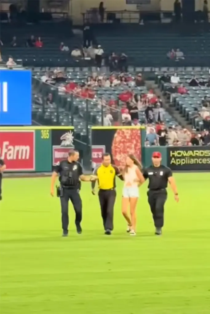 TikToker Arrested After Dancing on Angels Field — Fans Go Wild 1 Julia Hill being escorted off of the field