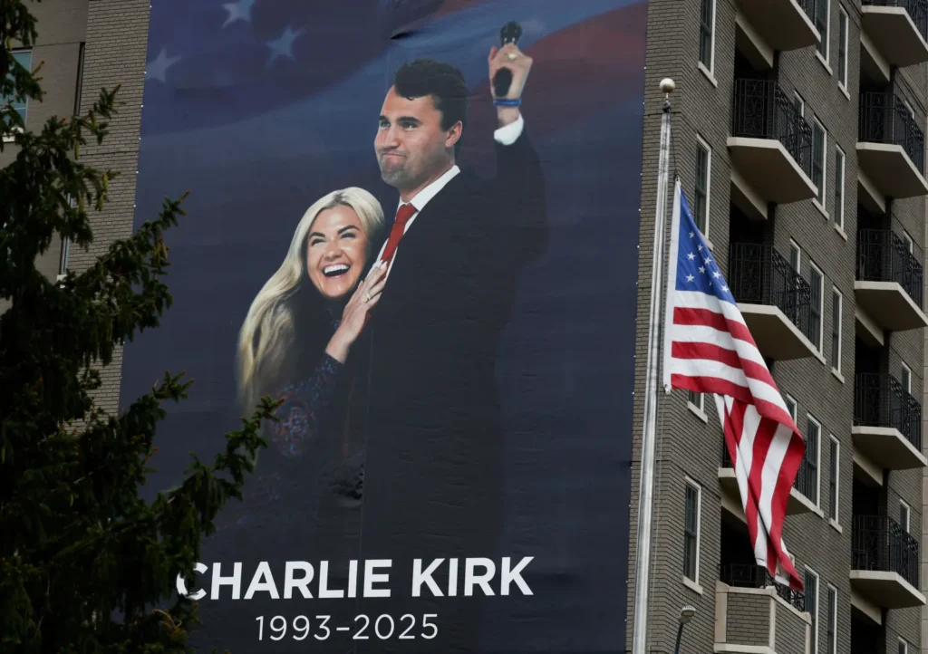 Widow Erika Kirk Keeps Blood-Stained Pendant of Late Husband 3 A memorial banner for Kirk is displayed on the side of the Heritage Foundation building