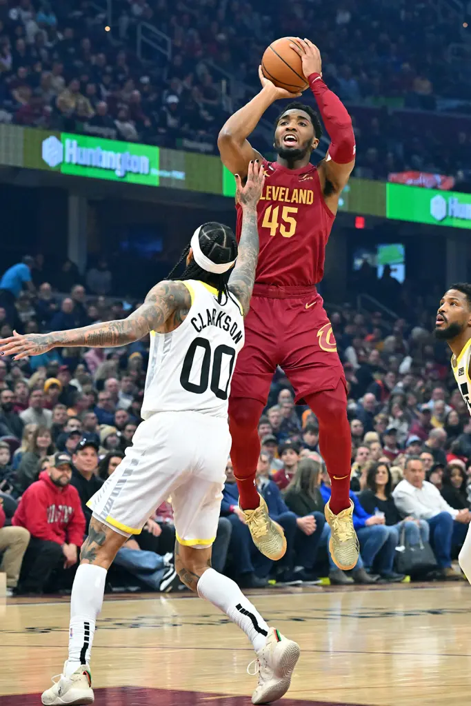 Cavaliers guard Donovan Mitchell shoots over Jordan Clarkson