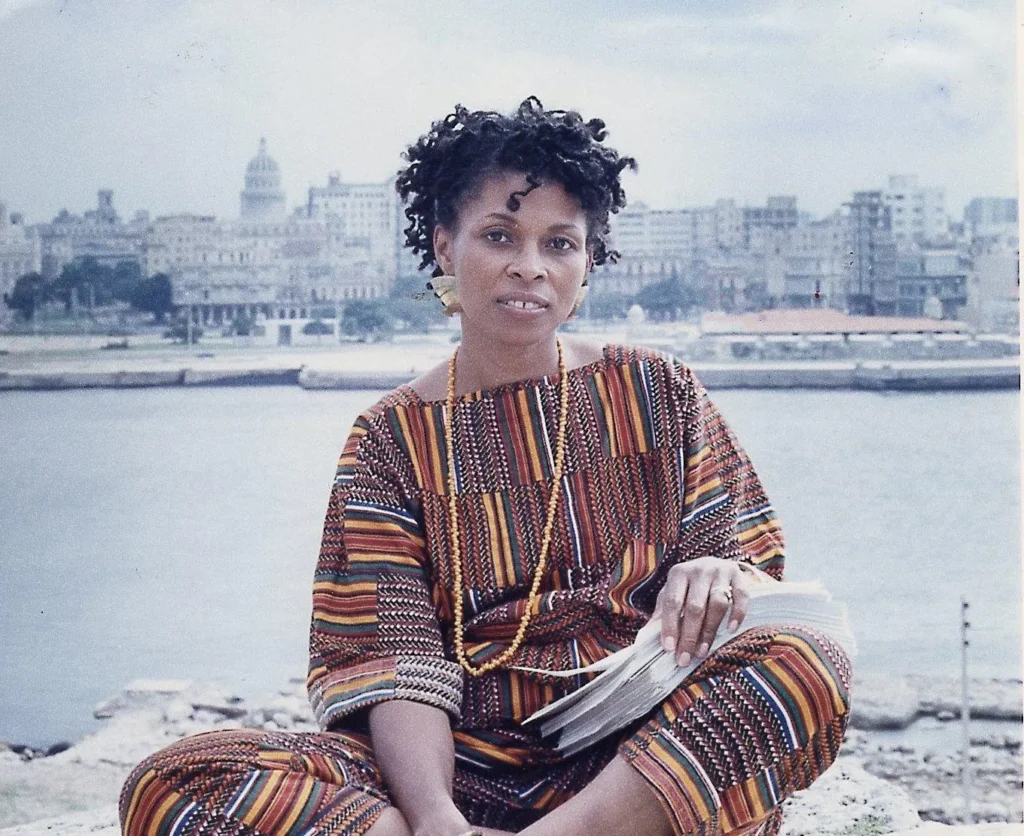 JoAnn Chesimard, aka Assata Shakur, holding the manuscript of her autobiography with Old Havana, Cuba,