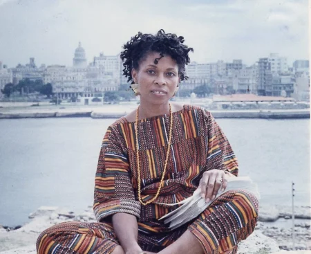 JoAnn Chesimard, aka Assata Shakur, holding the manuscript of her autobiography with Old Havana, Cuba,