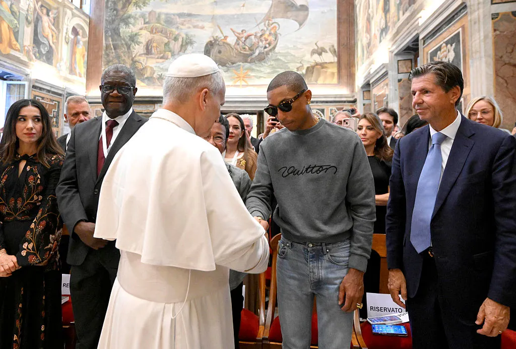 Pope Leo XIV greets US singer Pharrell Williams during a meeting