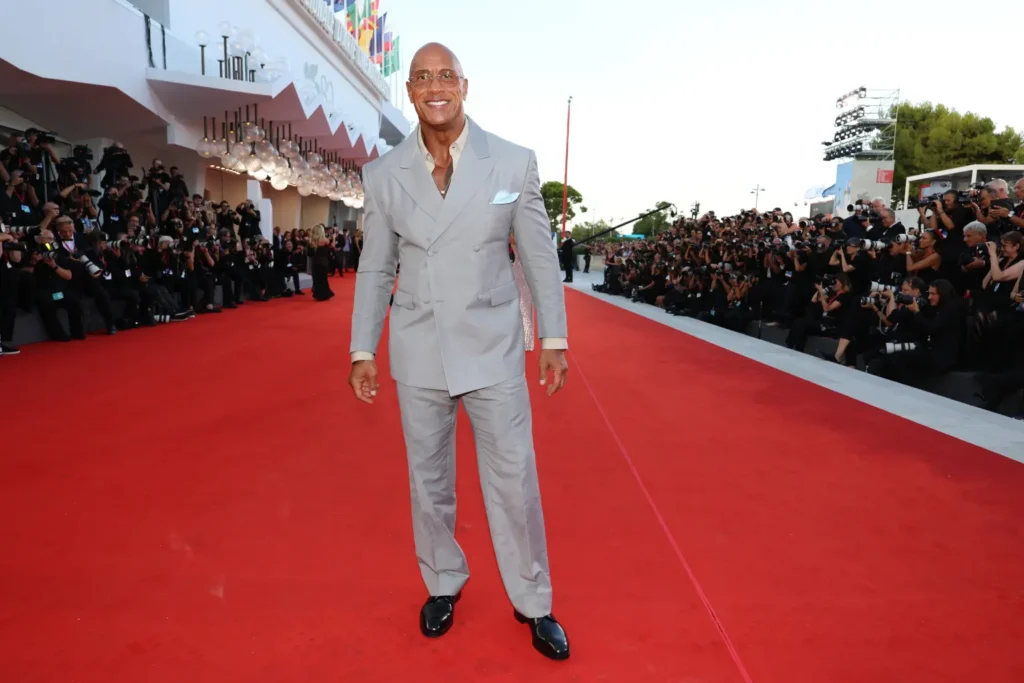 The actor, who underwent a significant weight loss transformation for the film, wore a gray double breasted suit for the red carpet premiere