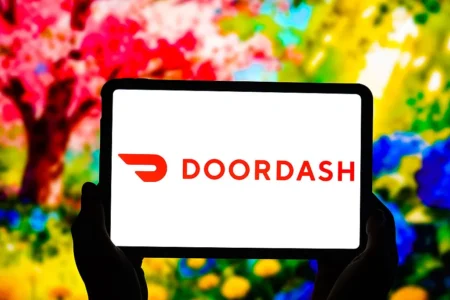 DoorDashs logo is displayed on the screen of the tablet