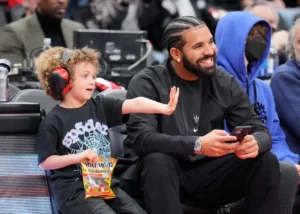 Drake Spotted Cheering at Son Adonis’s Soccer Game Drake sits with his son Adonis before the Toronto Raptors play the Philadelphia 76ers in their basketball game at the Scotiabank Arena