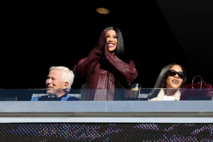 Cardi B Cheers on Stefon Diggs in Luxe Gillette Stadium Style Cardi B acknowledges the crowd during the game between the Atlanta Falcons and the New England Patriots at Gillette Stadium