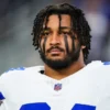 Marshawn Kneeland #94 of the Dallas Cowboys looks on from the sideline during the national anthem prior to an NFL football game against the Tampa Bay Buccaneers
