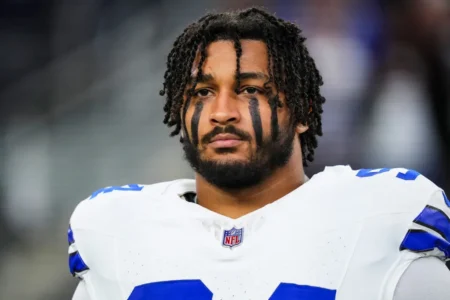 Marshawn Kneeland #94 of the Dallas Cowboys looks on from the sideline during the national anthem prior to an NFL football game against the Tampa Bay Buccaneers