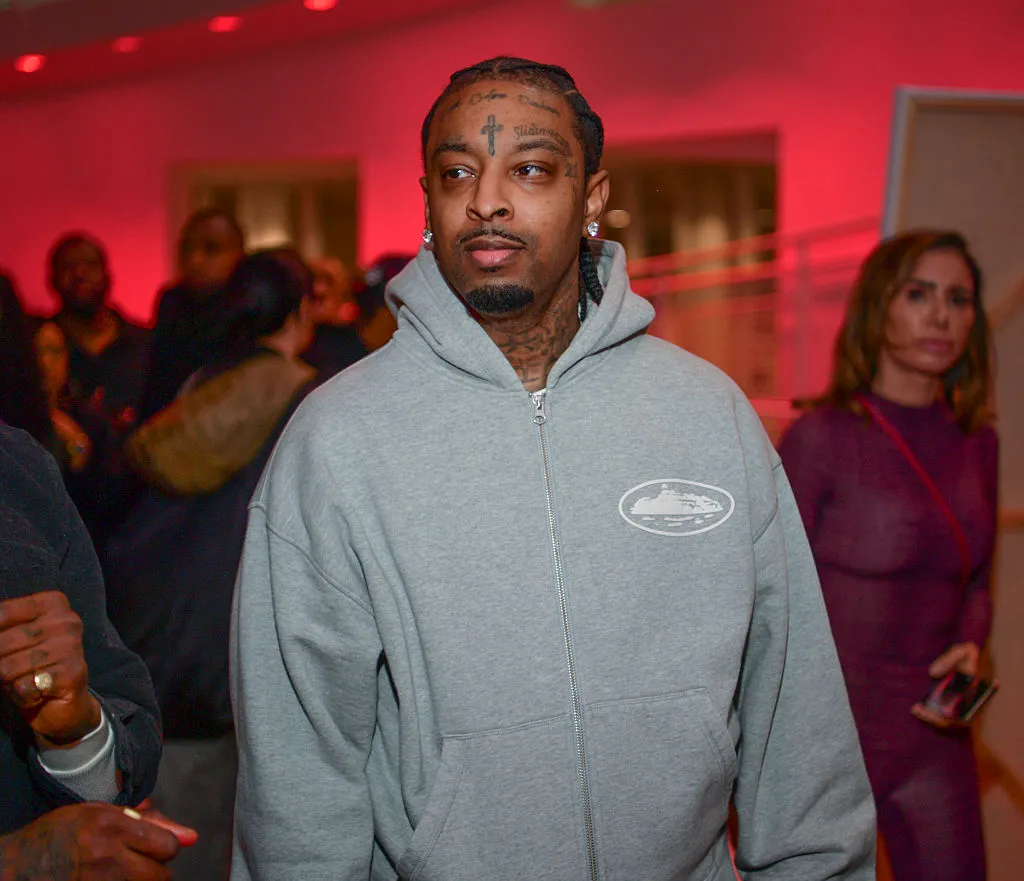 21 Savage Laughs Off Spotify Stream Drop: “That Sh*t Is Cap” 21 Savage attends What Happened To The Streets (WHTTS) Art Exhibition & Reception Works By Slawn