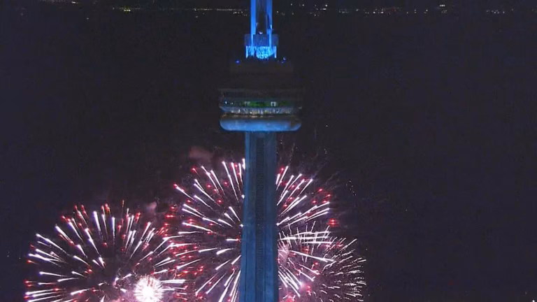 Fireworks explode as the CN Tower is frozen during Drake's album release