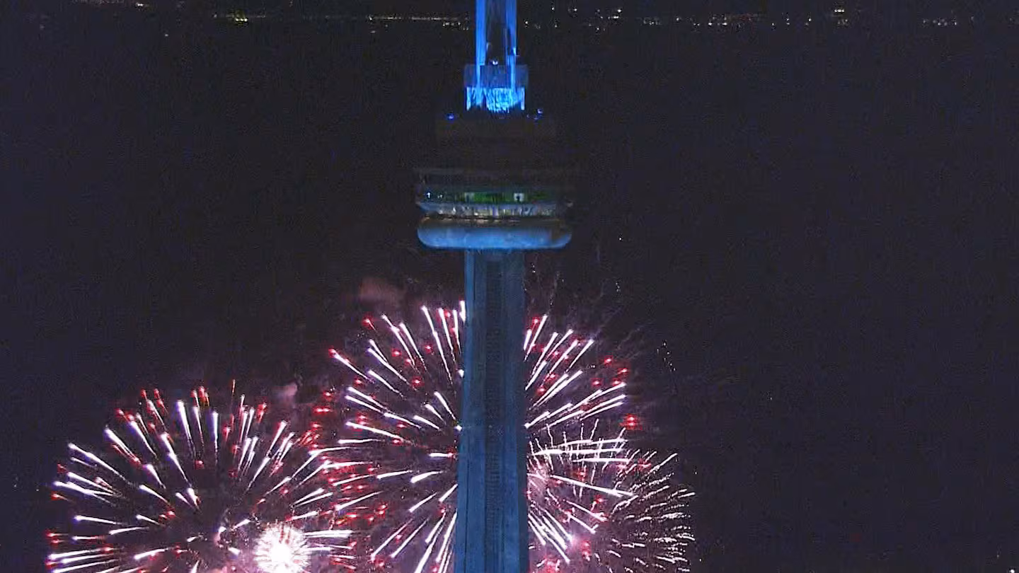 Fireworks explode as the CN Tower is frozen during Drake's album release