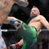 Conor McGregor kicks Max Holloway in a welterweight fight at UFC 329 on Saturday in Las Vegas.