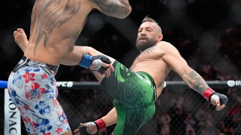 Conor McGregor kicks Max Holloway in a welterweight fight at UFC 329 on Saturday in Las Vegas.