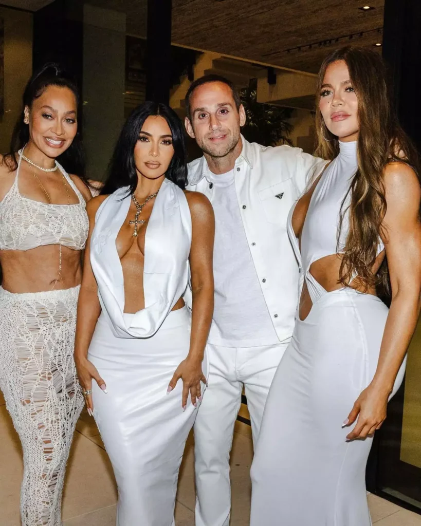 Kim and Khloe Kardashian pose with Michael Rubin at the White Party.