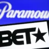 BET logo seen on a smartphone and Paramount Global logo on a pc screen