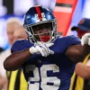 Devin Singletary #26 of the New York Giants reacts after a first down during the fourth quarter against the Dallas Cowboys at MetLife Stadium on September 13, 2026 in East Rutherford, New Jersey.