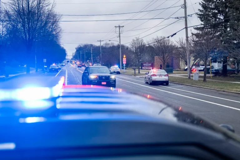 A large police presence lines the street in front of Abundant Life Christian School after a school shooting on December 16, 2024 in Madison, Wisconsin.